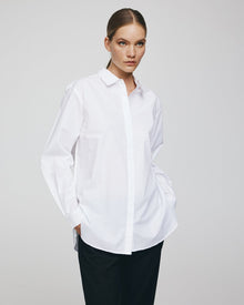 MSCH Copenhagen Olisa Shirt in white, crafted from 100% organic cotton with a loose fit and smooth finish. Features a classic pointed collar, full button front closure, long sleeves with buttoned cuffs, and a softly curved hem for an effortless everyday style.