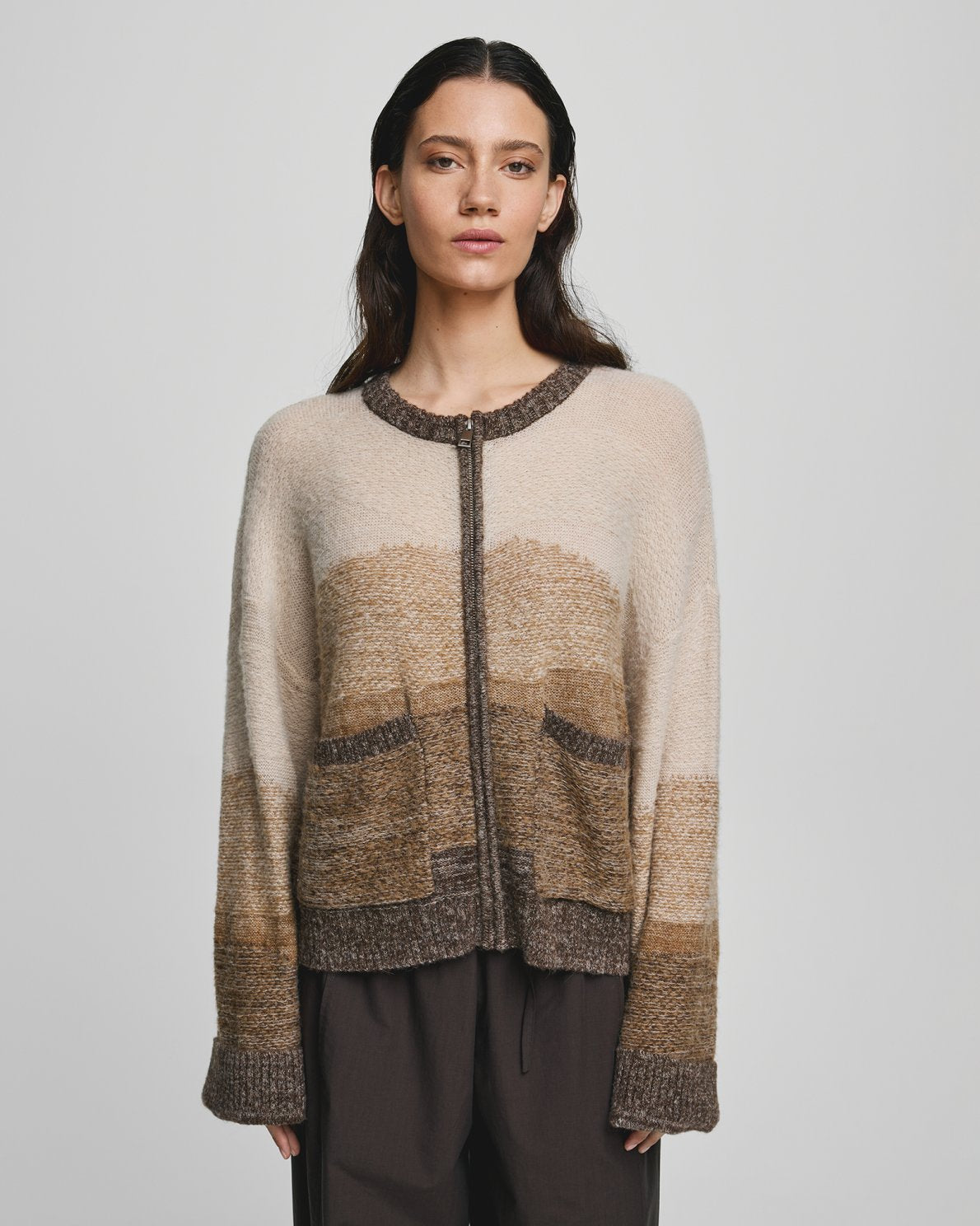 Sasha Zip Cardigan by MSCH Copenhagen
 in a multicolor knitted design with soft tonal transitions. Features a loose, straight-fit silhouette with a front zip closure, long straight sleeves, ribbed cuffs, ribbed hem, and round neckline. Hip-length style crafted from a soft wool-blend knit with alpaca for added warmth and texture. Model is 173 cm tall and wears size S/M.