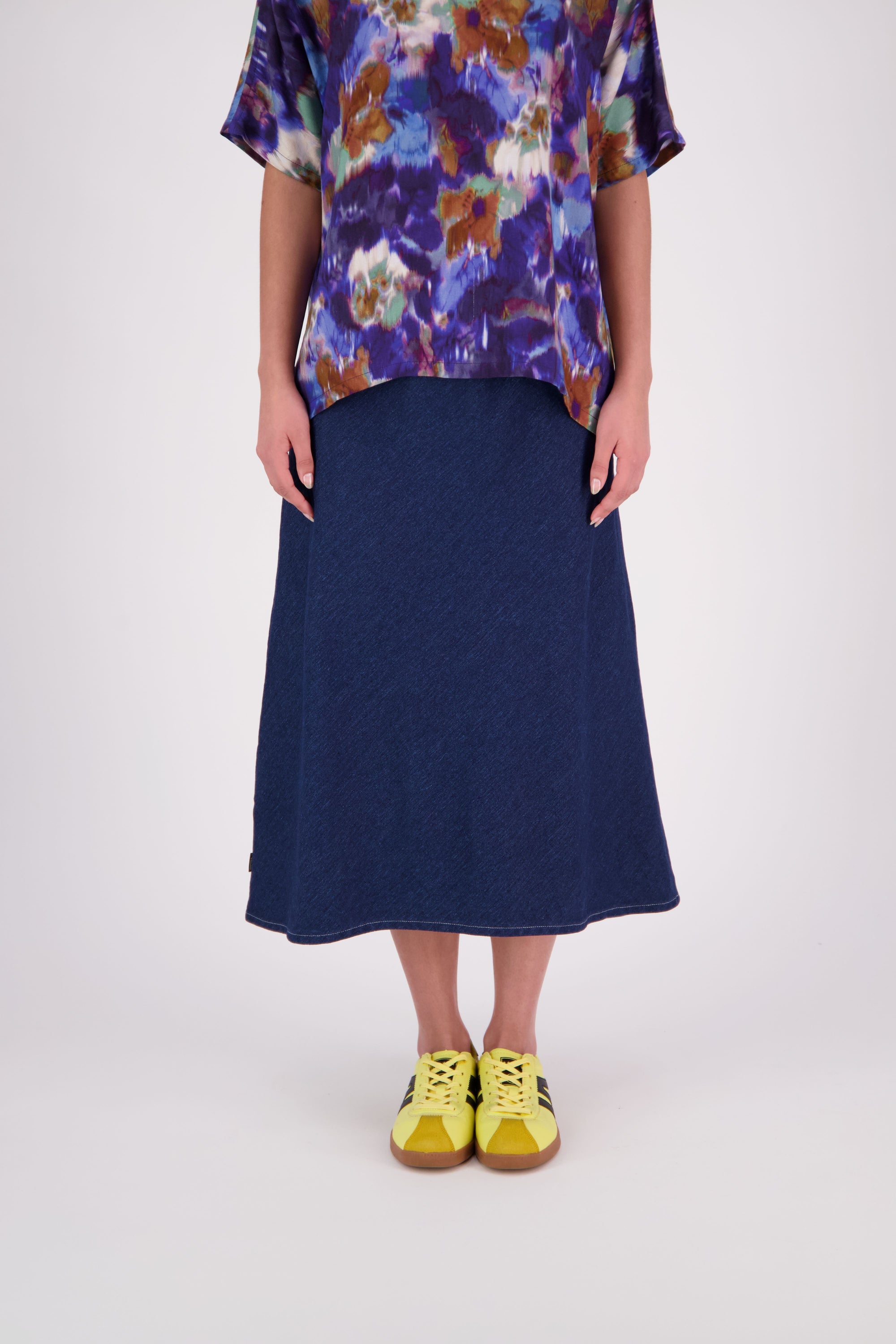 N-E-S Denim Muse Skirt
Our bestselling Muse Skirt gets a fresh update in classic denim with crisp white topstitching along the hemline. Designed with a flattering bias cut, wide elasticated waistband, and signature concave front with a dropped back hem, this skirt offers effortless style and all-day comfort. A versatile, multi-seasonal staple you’ll reach for again and again.