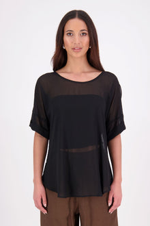 A customer favourite, the NES Cross Top is crafted in lightweight chiffon for an easy, elegant drape. This flattering t-shirt style features mid-length sleeves with folded cuffs, a soft scooped hem, and a unique crossover yoke detail that wraps from front to back. Perfect dressed up or down, and best layered with a NES Lattice Singlet underneath for coverage and style.

Our model is 174cm and wears a XS (8) NES fit advise: Standard fit

Composition: PT Chiffon

Designed and Made in New Zealand