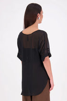 A customer favourite, the NES Cross Top is crafted in lightweight chiffon for an easy, elegant drape. This flattering t-shirt style features mid-length sleeves with folded cuffs, a soft scooped hem, and a unique crossover yoke detail that wraps from front to back. Perfect dressed up or down, and best layered with a NES Lattice Singlet underneath for coverage and style.

Our model is 174cm and wears a XS (8) NES fit advise: Standard fit

Composition: PT Chiffon

Designed and Made in New Zealand