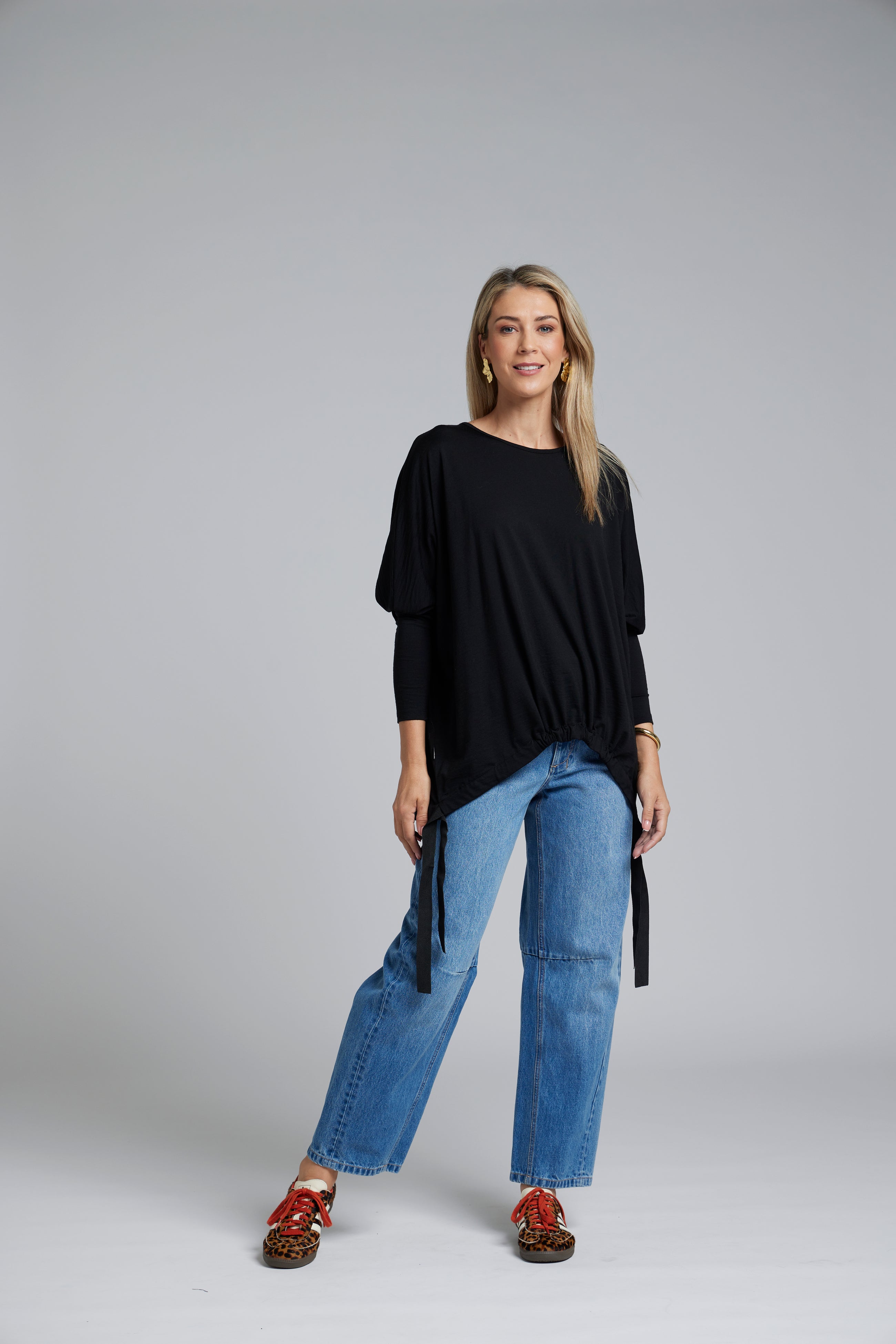 The NES Merino Vanotti Top – a warm merino take on the N-E-S favourite with cigarette sleeves, scoop neck and signature draped hem. NZ made.