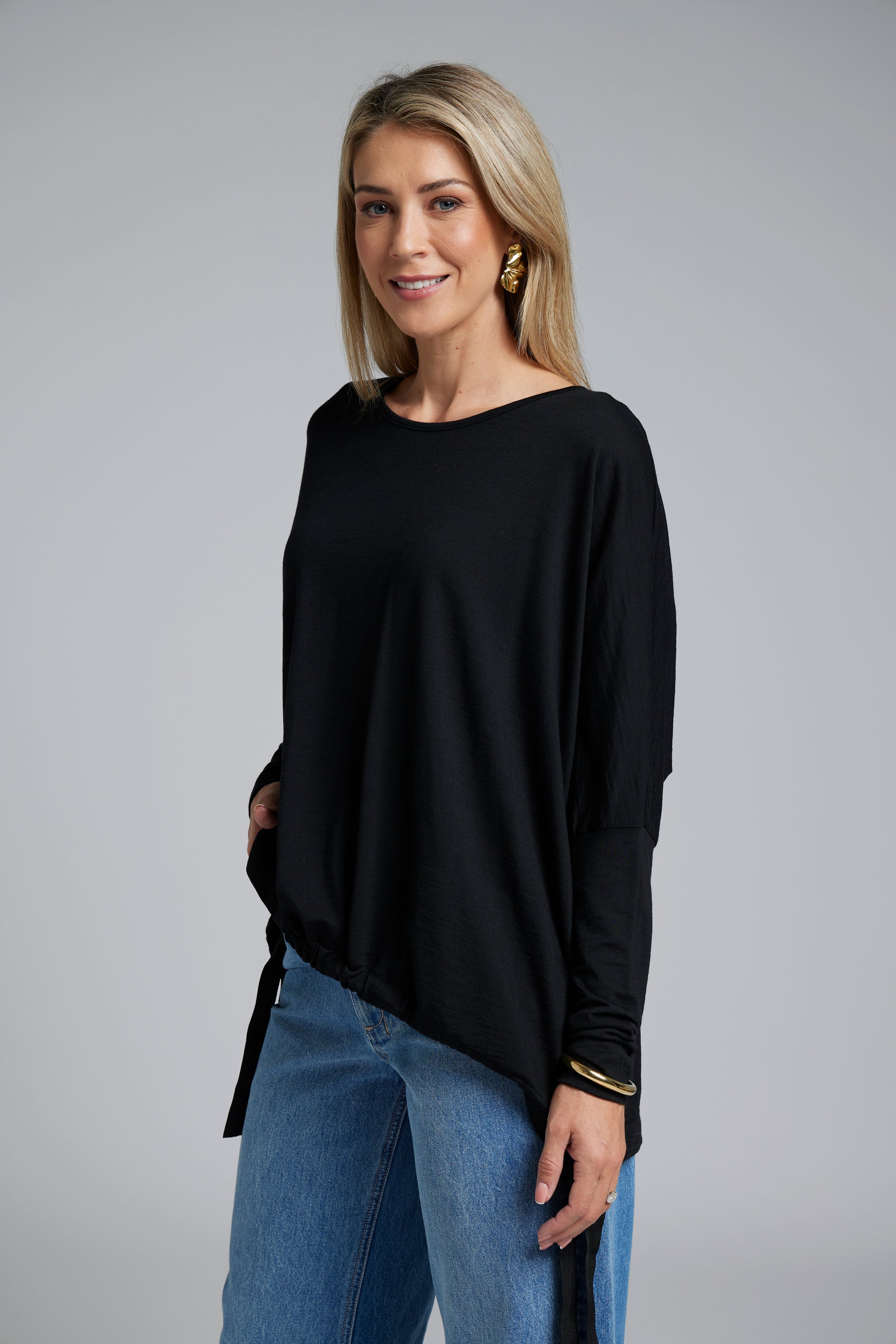 The NES Merino Vanotti Top – a warm merino take on the N-E-S favourite with cigarette sleeves, scoop neck and signature draped hem. NZ made.