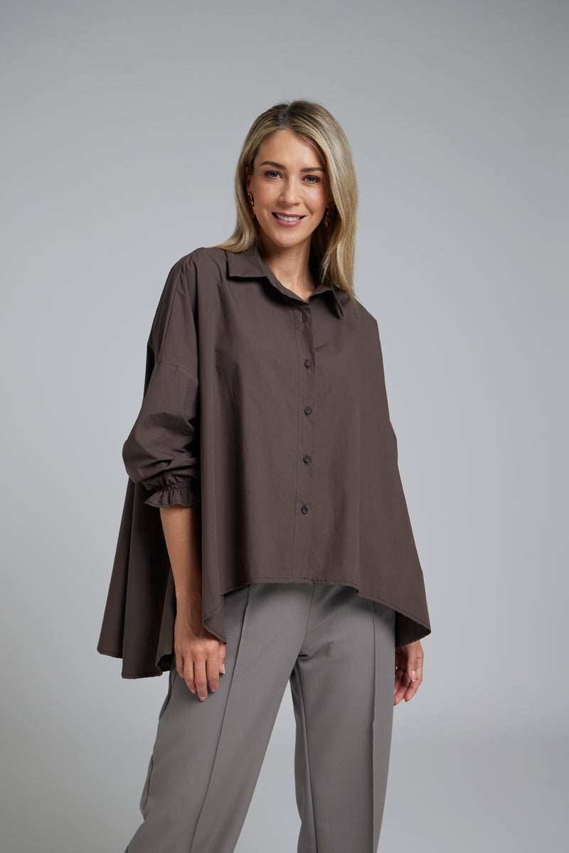 The NES Vey Shirt by N-E-S – a relaxed cotton shirt with 7/8 sleeves, three-row shirred cuffs and soft umbrella silhouette. In stripe or Kenzo Choc. NZ made.