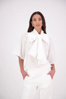 The N-E-S Nova Shirt blends the best of our Ayla, Mon, and Del shirts into one must-have wardrobe piece. Featuring elbow-length sleeves, a soft drop hem at the front and back, and a playful neck tie that can be styled multiple ways—bowed, looped, or reversed and tied at the back. Designed for versatility and charm, the Nova Shirt is a timeless addition to elevate your everyday style.

Our model is 174cm and wear a XS/S (8-10)

Composition: Cotton

Designed and Made in New Zealand