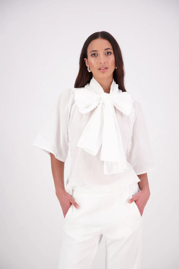 The N-E-S Nova Shirt blends the best of our Ayla, Mon, and Del shirts into one must-have wardrobe piece. Featuring elbow-length sleeves, a soft drop hem at the front and back, and a playful neck tie that can be styled multiple ways—bowed, looped, or reversed and tied at the back. Designed for versatility and charm, the Nova Shirt is a timeless addition to elevate your everyday style.

Our model is 174cm and wear a XS/S (8-10)

Composition: Cotton

Designed and Made in New Zealand