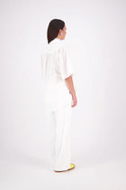 The N-E-S Nova Shirt blends the best of our Ayla, Mon, and Del shirts into one must-have wardrobe piece. Featuring elbow-length sleeves, a soft drop hem at the front and back, and a playful neck tie that can be styled multiple ways—bowed, looped, or reversed and tied at the back. Designed for versatility and charm, the Nova Shirt is a timeless addition to elevate your everyday style.

Our model is 174cm and wear a XS/S (8-10)

Composition: Cotton

Designed and Made in New Zealand