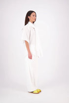 The N-E-S Nova Shirt blends the best of our Ayla, Mon, and Del shirts into one must-have wardrobe piece. Featuring elbow-length sleeves, a soft drop hem at the front and back, and a playful neck tie that can be styled multiple ways—bowed, looped, or reversed and tied at the back. Designed for versatility and charm, the Nova Shirt is a timeless addition to elevate your everyday style.

Our model is 174cm and wear a XS/S (8-10)

Composition: Cotton

Designed and Made in New Zealand