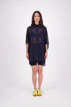 The N-E-S Oby Shirt Dress is a floaty chiffon piece with a batwing silhouette and tunic-length finish. Designed with a classic collar and centre front button-through placket, it features a waist loop and button so you can wear it loose and open or cinched for a more defined shape. Great worn on its own or styled back with slim or wide leg trousers or denim shorts for a relaxed, effortless look.

Our model is 174cm and wears a XS/S (8-10)

Composition: PT Chiffon

Designed and Made in New Zealand