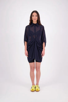 The N-E-S Oby Shirt Dress is a floaty chiffon piece with a batwing silhouette and tunic-length finish. Designed with a classic collar and centre front button-through placket, it features a waist loop and button so you can wear it loose and open or cinched for a more defined shape. Great worn on its own or styled back with slim or wide leg trousers or denim shorts for a relaxed, effortless look.

Our model is 174cm and wears a XS/S (8-10)

Composition: PT Chiffon

Designed and Made in New Zealand