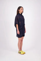 The N-E-S Oby Shirt Dress is a floaty chiffon piece with a batwing silhouette and tunic-length finish. Designed with a classic collar and centre front button-through placket, it features a waist loop and button so you can wear it loose and open or cinched for a more defined shape. Great worn on its own or styled back with slim or wide leg trousers or denim shorts for a relaxed, effortless look.

Our model is 174cm and wears a XS/S (8-10)

Composition: PT Chiffon

Designed and Made in New Zealand