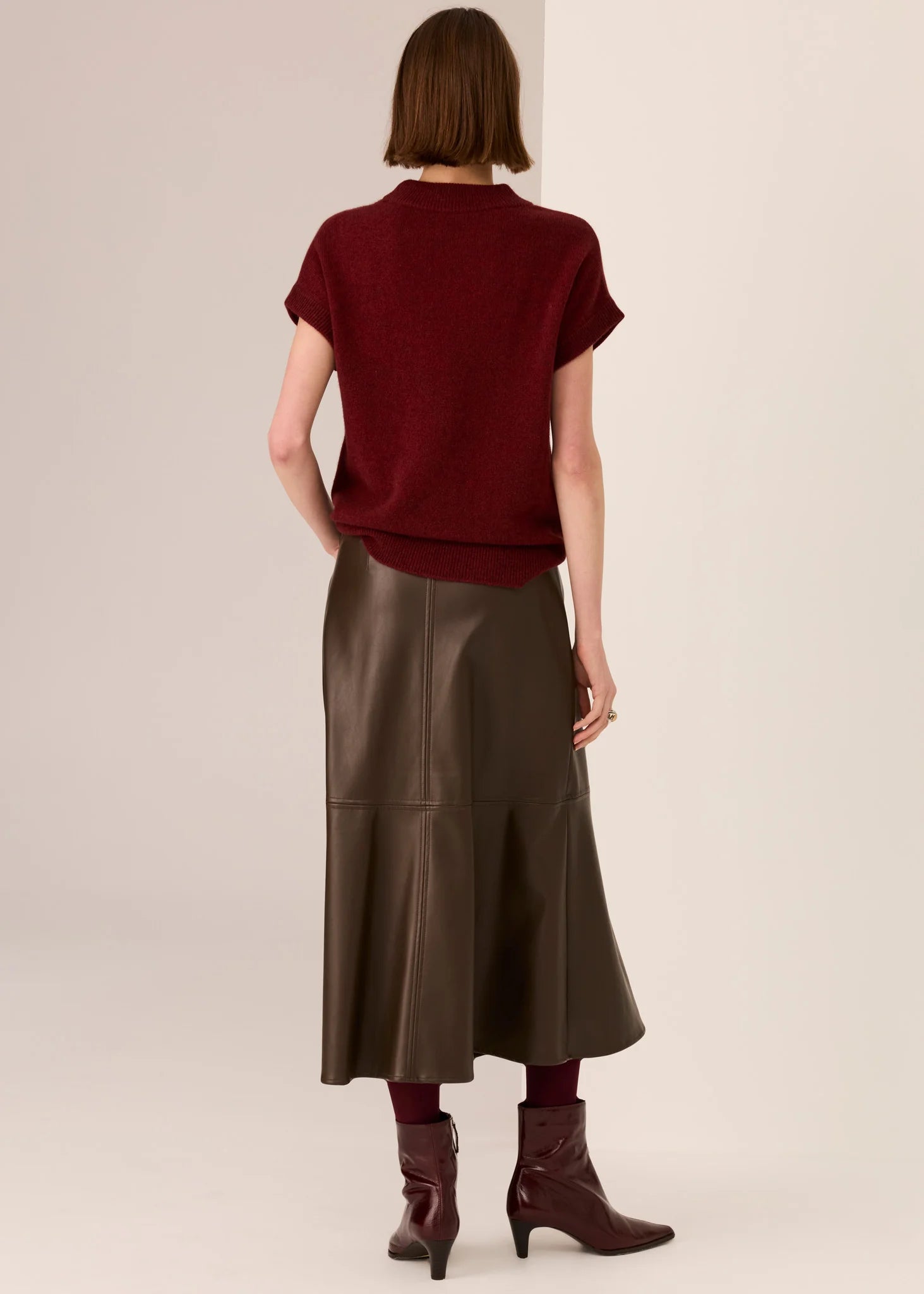 POL Astor Turtleneck Tee in a Yak and extrafine Merino blend, featuring a ribbed mock neck, dropped armholes and cap sleeves, finished with a relaxed fit and ribbed hem, available in Pebble and Wine
