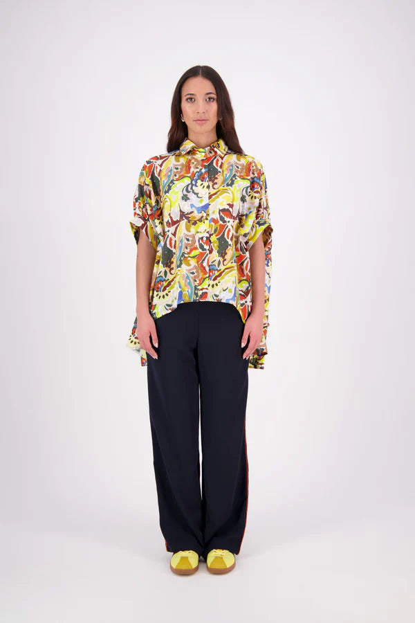 Ryn Shirt – Effortless Volume &amp; Soft Structure

The N-E-S Ryn Shirt is a COTTON SHIRT modern take on a classic, crafted in breathable cotton. With its umbrella-style silhouette, it features a centre front button-down placket, kimono-style sleeves gathered into soft cuffs, and a slight high-low hem. Easy to style back with pants, shorts, or skirts—this is your go-to shirt for relaxed yet elevated dressing.