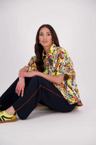 Ryn Shirt – Effortless Volume &amp; Soft Structure

The N-E-S Ryn Shirt is a COTTON SHIRT modern take on a classic, crafted in breathable cotton. With its umbrella-style silhouette, it features a centre front button-down placket, kimono-style sleeves gathered into soft cuffs, and a slight high-low hem. Easy to style back with pants, shorts, or skirts—this is your go-to shirt for relaxed yet elevated dressing.