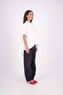 Ryn cotton Shirt – Effortless Volume & Soft Structure

The N-E-S Ryn Shirt is a modern take on a classic, crafted in breathable cotton. With its umbrella-style silhouette, it features a centre front button-down placket, kimono-style sleeves gathered into soft cuffs, and a slight high-low hem. Easy to style back with pants, shorts, or skirts—this is your go-to shirt for relaxed yet elevated dressing.