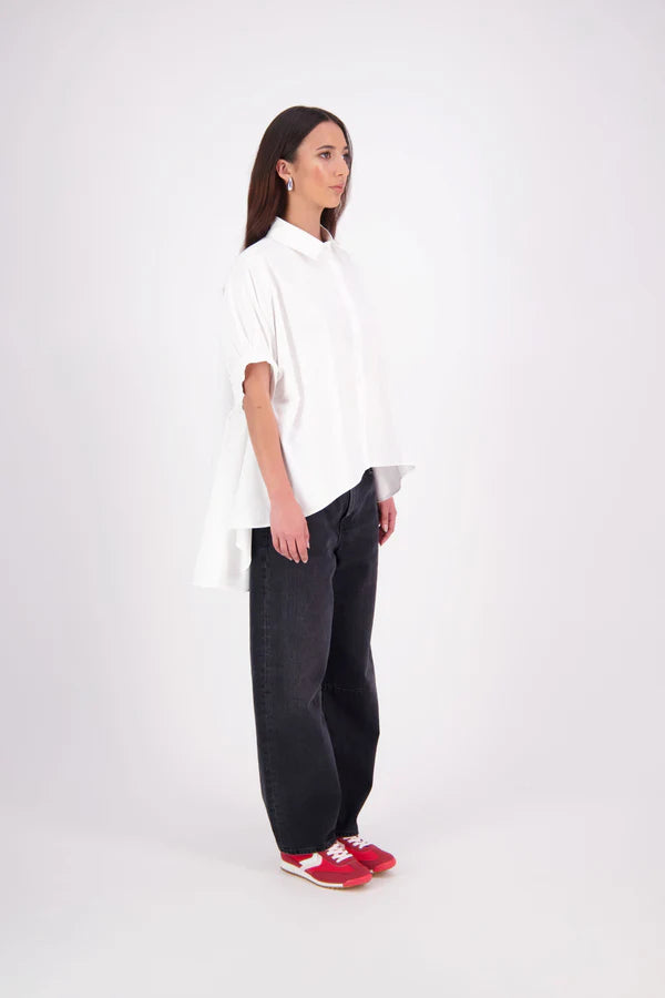 Ryn cotton Shirt – Effortless Volume & Soft Structure

The N-E-S Ryn Shirt is a modern take on a classic, crafted in breathable cotton. With its umbrella-style silhouette, it features a centre front button-down placket, kimono-style sleeves gathered into soft cuffs, and a slight high-low hem. Easy to style back with pants, shorts, or skirts—this is your go-to shirt for relaxed yet elevated dressing.
