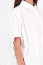 Ryn cotton Shirt – Effortless Volume & Soft Structure

The N-E-S Ryn Shirt is a modern take on a classic, crafted in breathable cotton. With its umbrella-style silhouette, it features a centre front button-down placket, kimono-style sleeves gathered into soft cuffs, and a slight high-low hem. Easy to style back with pants, shorts, or skirts—this is your go-to shirt for relaxed yet elevated dressing.