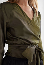 Load image into Gallery viewer, Elevated elegance for the everyday and beyond. The Elk Medjal Top is a sophisticated wrap-style blouse crafted in a striking black and gold palette—designed to shine in evening settings or refined daytime looks. With its flattering wrap silhouette, soft drape, and subtle sheen, it’s the perfect transseasonal piece for effortless dressing.

Made from a luxurious blend of viscose and eco-conscious Ecovero™, the Medjal Top offers breathable comfort with a silky finish. Pair it with tailored trousers or high-wa
