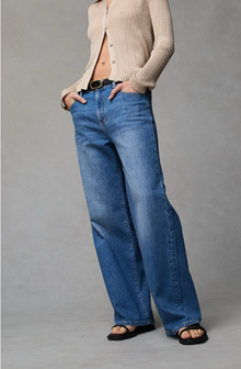 Dricoper Zelda jeans in Rodeo Blue, designed with a relaxed baggy fit, mid-to-high rise waist, and wide loose legs that fall to the floor for a laid-back ’90s-inspired look.